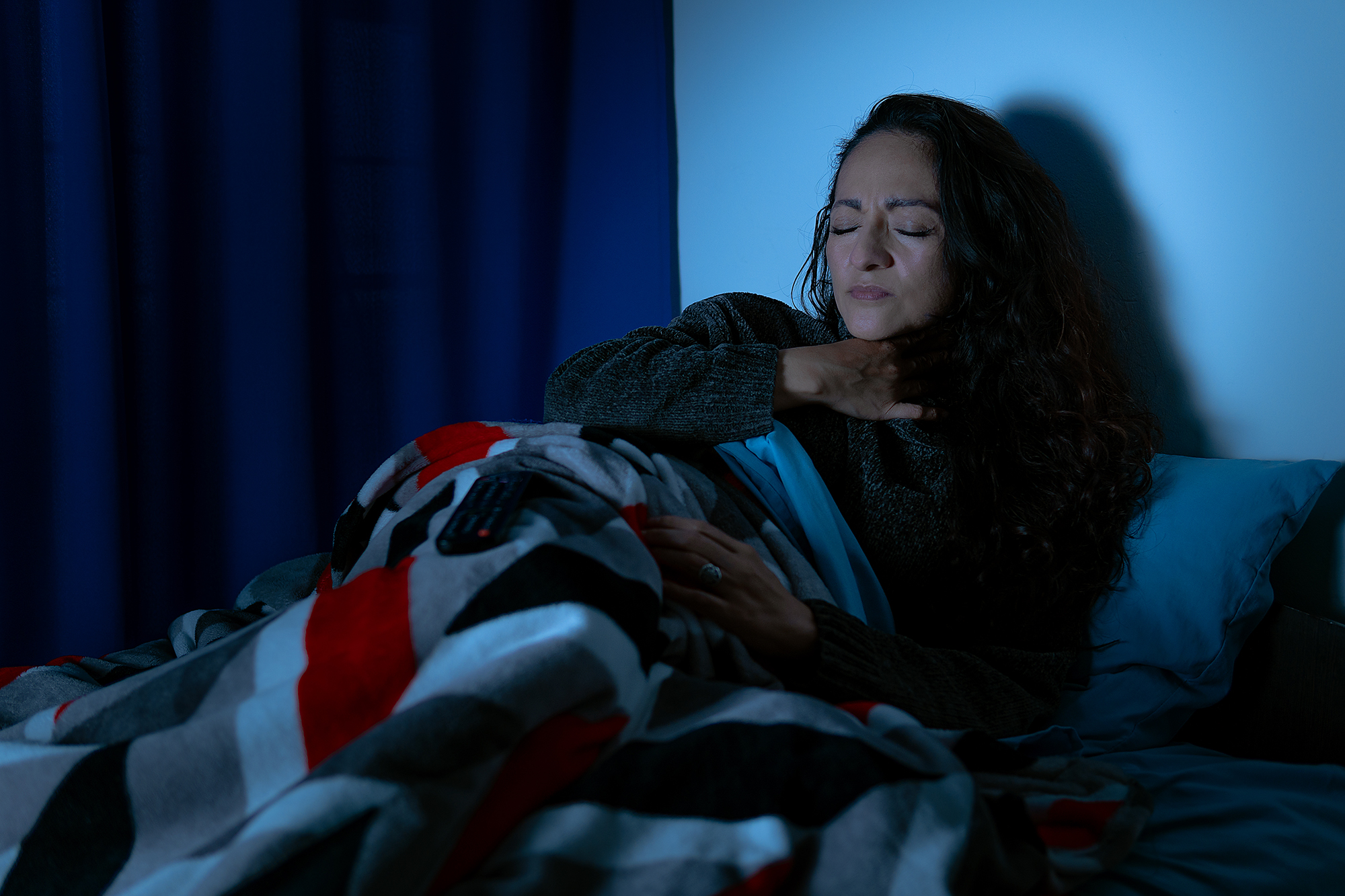 Mujer en la cama, afectada por la tos